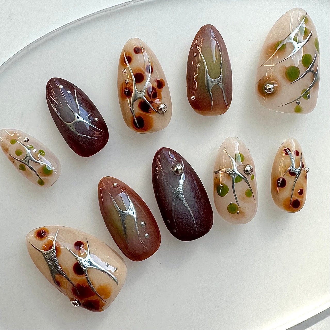 Short almond nails press-on set showcasing mesmerizing ombre nail art designs