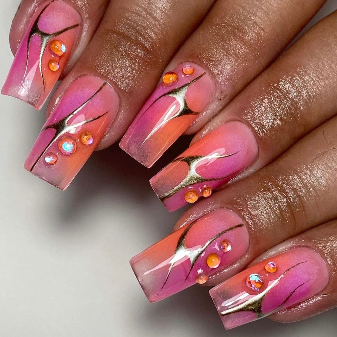 Experience the captivating allure of our 'Pink to Orange Ombre' nails. Seamlessly transitioning from delicate pink to vibrant orange hues, each nail embodies the breathtaking beauty of a summer sunset. Elevate your style with this stunning gradient design, perfect for embracing the carefree vibes of the season with flair and sophistication.