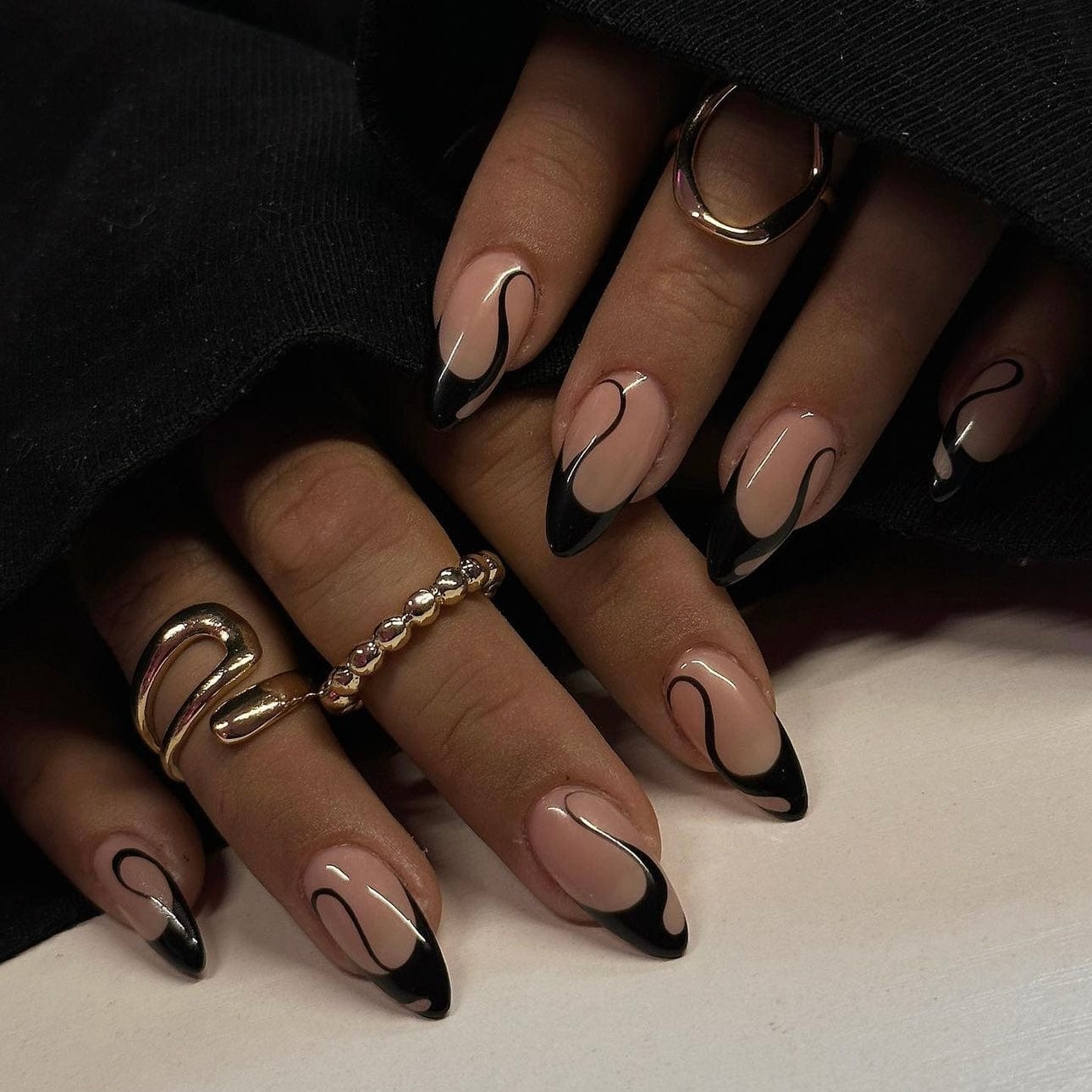 Black press-on nails with a sleek, bold design for a striking manicure.