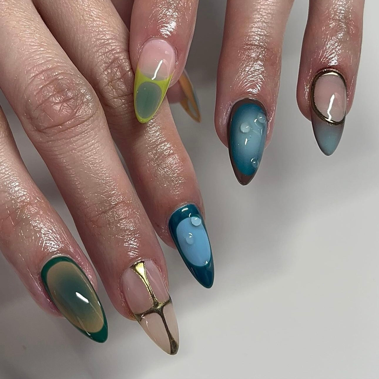 Blue and green ombre nails with sage green press-ons, showcasing a sophisticated gradient from serene blue to calming green for an elegant manicure.