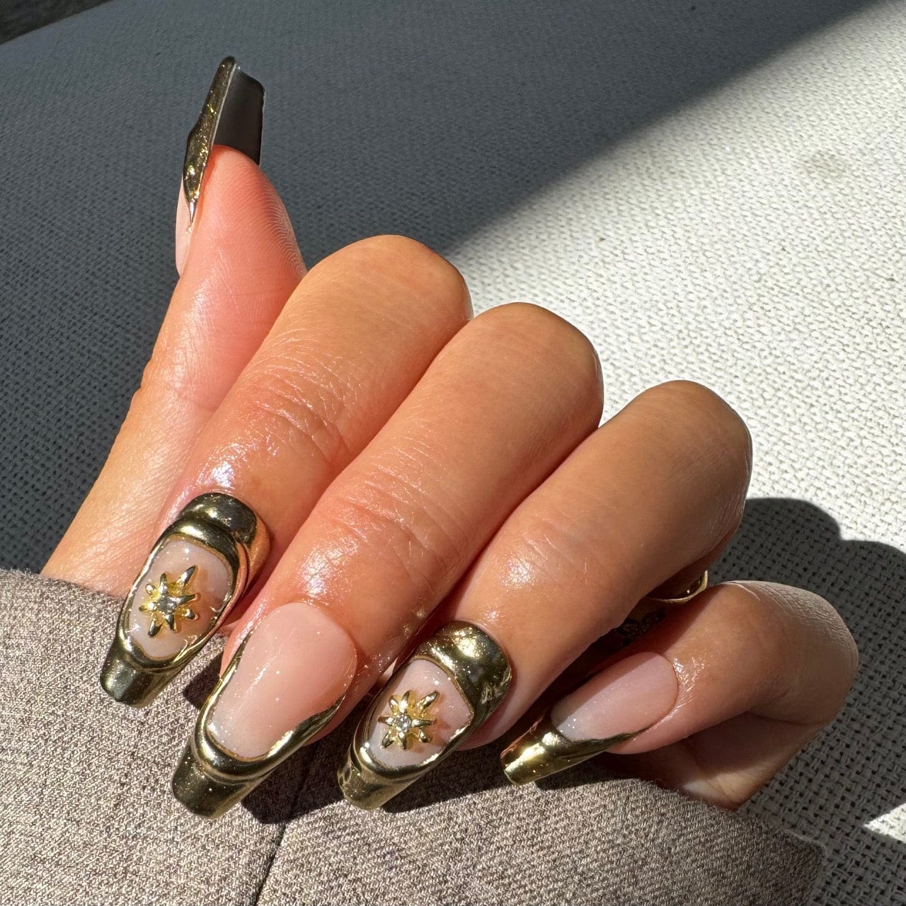 Gold French tip nails with elegant design