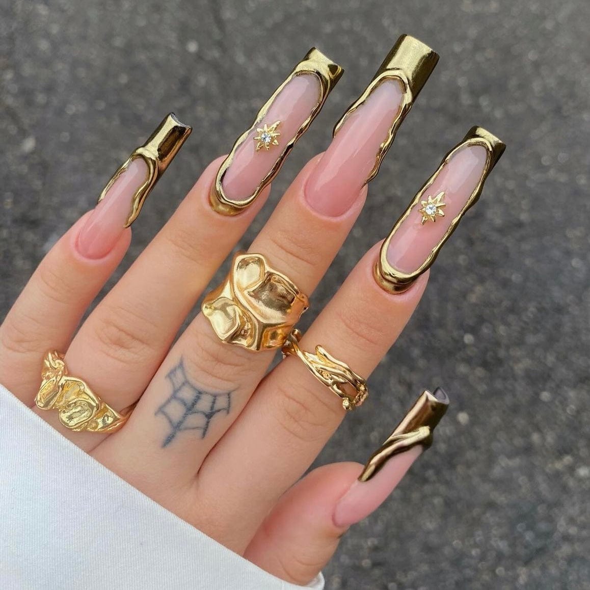 Gold French tip nails with elegant design