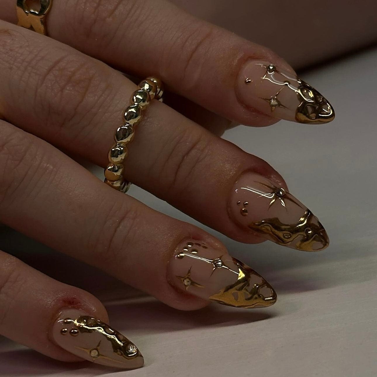 Gold French tip nails with elegant design