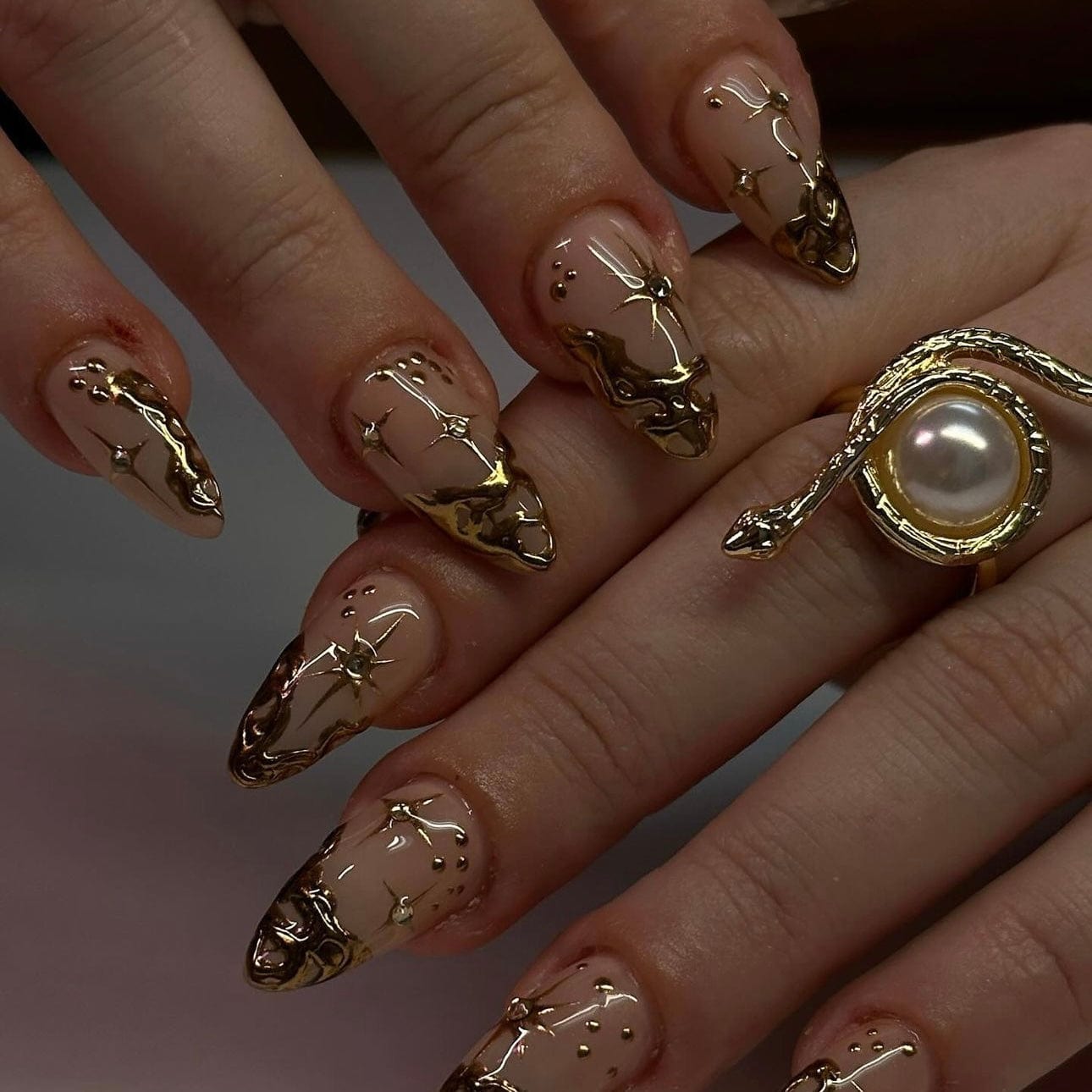 French tips adorned with shimmering gold accents