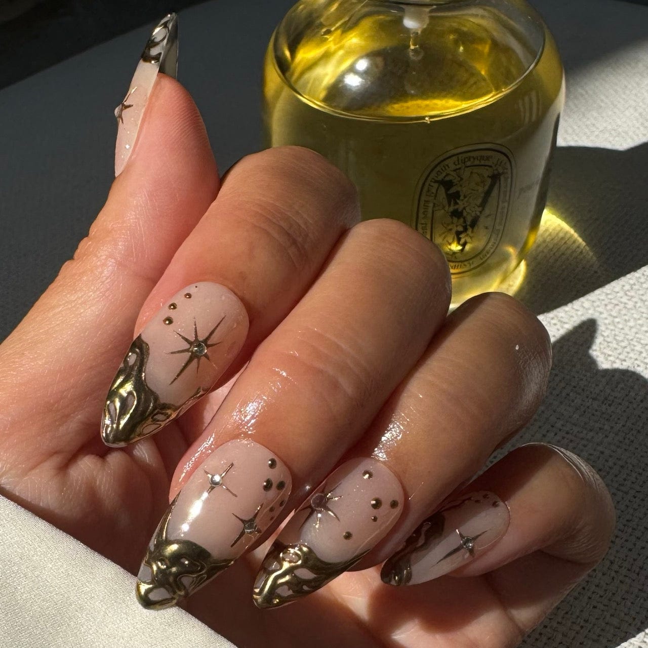 French tips adorned with shimmering gold accents