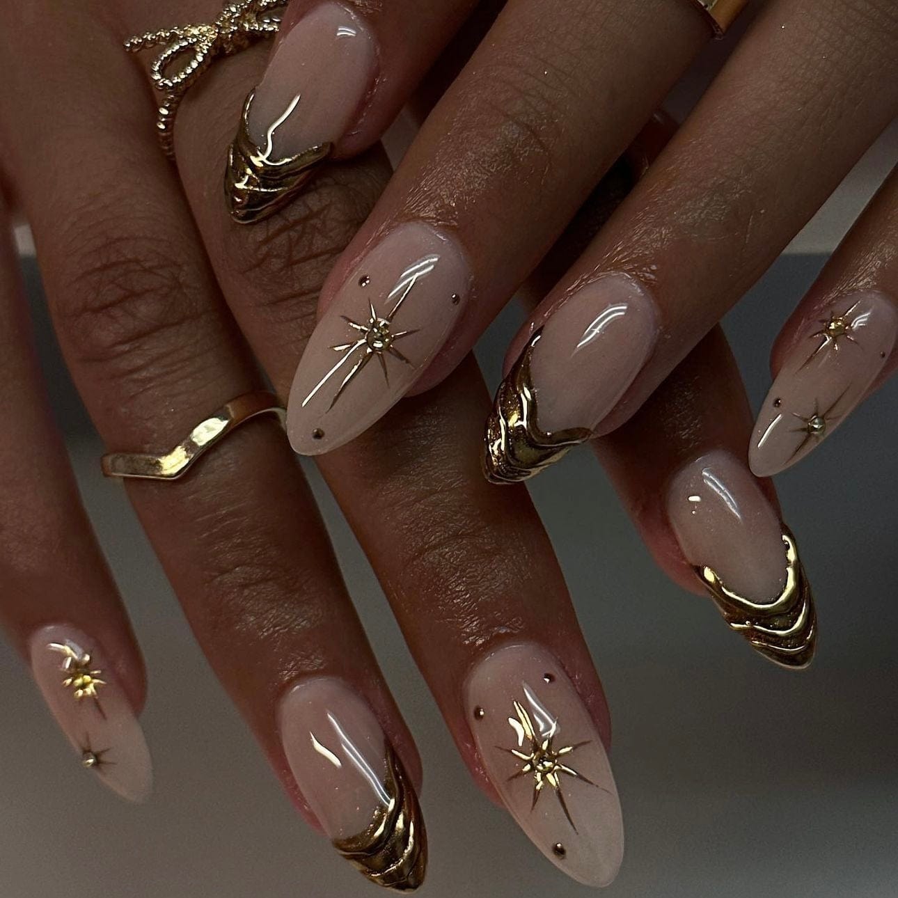 French tips adorned with shimmering gold accents