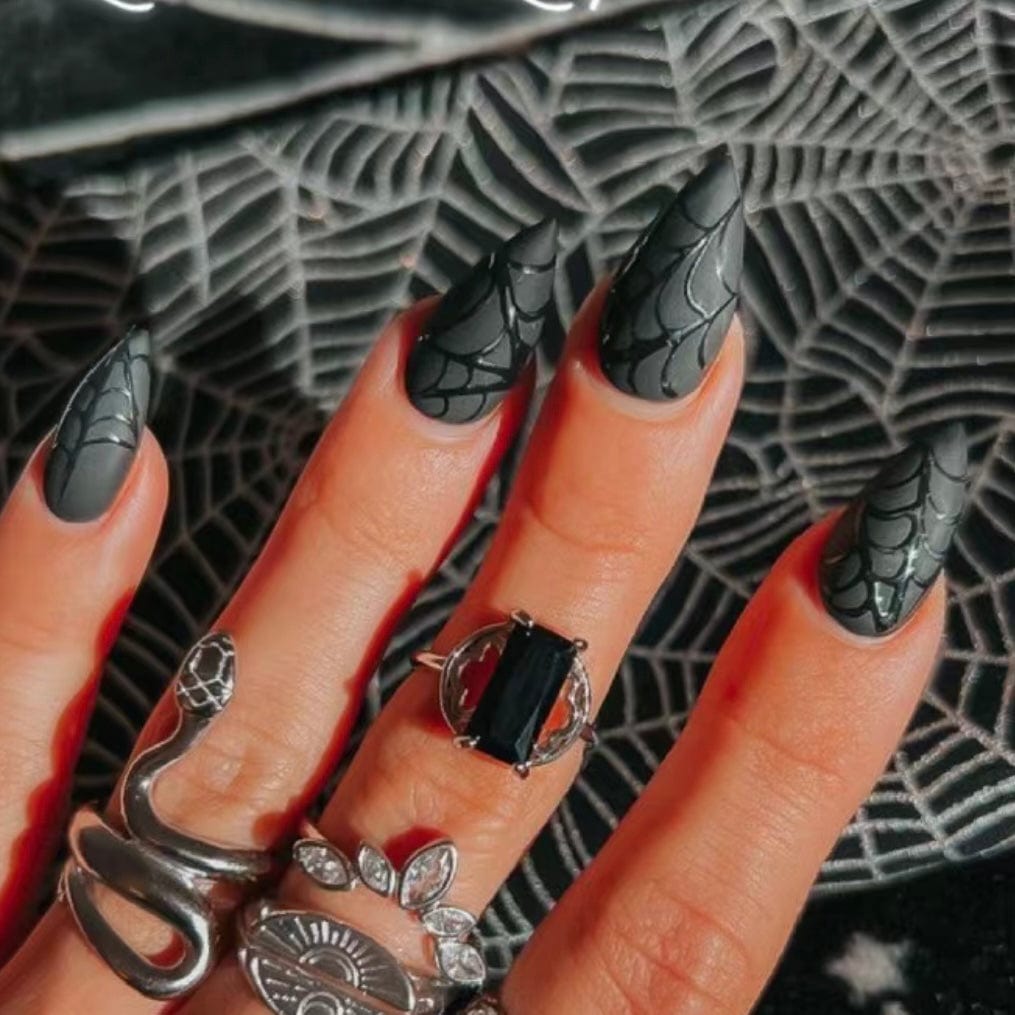 Halloween black nails featuring spider web designs and simple Halloween nails for a stylish and spooky manicure.