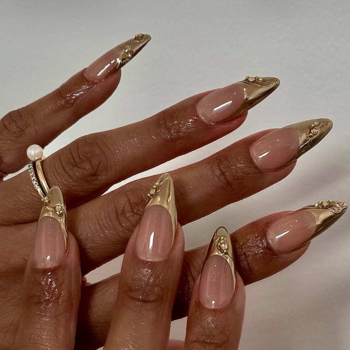 Gold French nails combining classic design with a luxurious twist