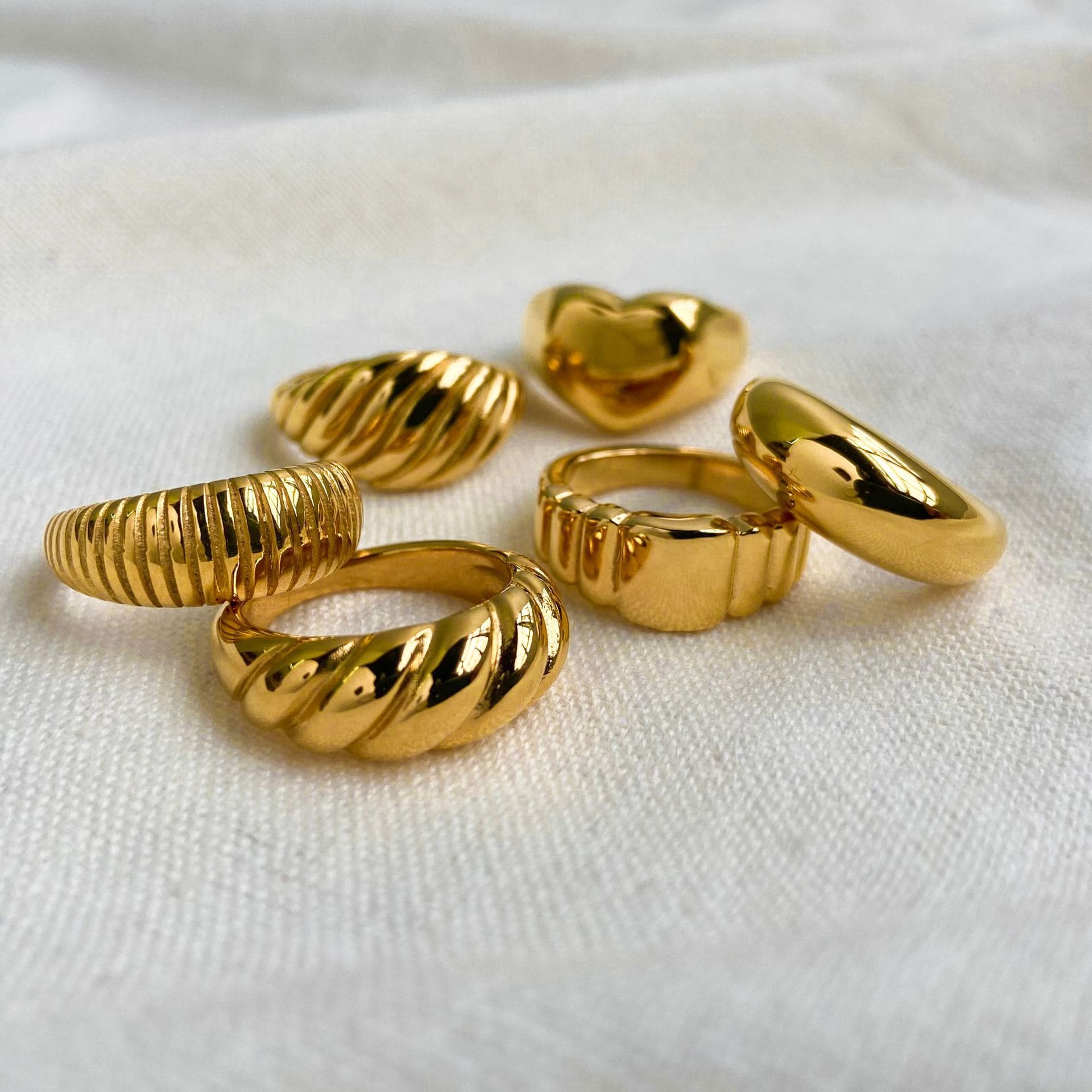 Trendy chunky gold ring stacked with other rings