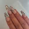 Chrome coffin nails in silver and gold tones, showcasing trendy and glamorous nail designs